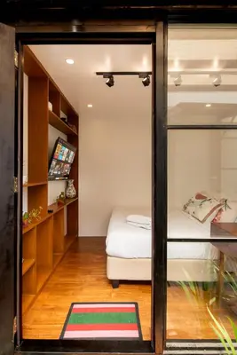a room with a bed and a glass wall at Container Home Mandaluyong N05 in Manila