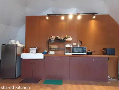 a kitchen with a counter top with a microwave at Container Home Mandaluyong N10 in Manila
