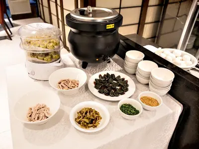 a counter with bowls of food and a mixer at Jinjiang Inn - Makati in Manila