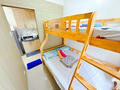 a small room with two bunk beds and a kitchen at Manila Bay View Shore1 Residence Tower A in Manila