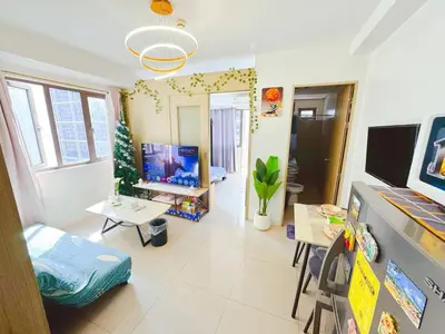 a room with a living room with a television and a living room at Manila Bay View Shore1 Residence Tower A in Manila