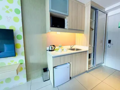 a small kitchen with a sink and a refrigerator at Hotel101 - Manila in Manila