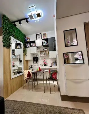 a dining room with a table and chairs in a room at City Escape by Fame in Manila