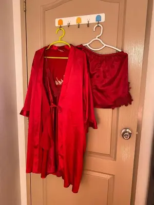 a red dress is hanging on a door at Your Comfort Zone Staycation2 in Manila