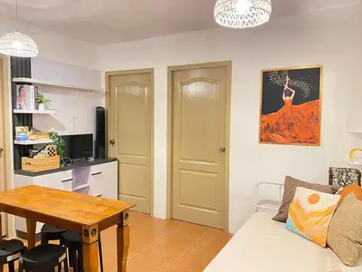a living room with a white couch and a table at Your Comfort Zone Staycation2 in Manila