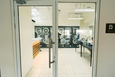 an open door to a laundry room with washing machines at Mellow Dreams in Manila