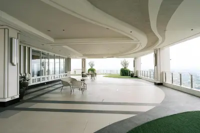 a large hallway with tables and chairs in a building at Mellow Dreams in Manila