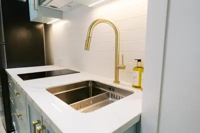 a kitchen with a sink and a faucet at Mellow Dreams in Manila