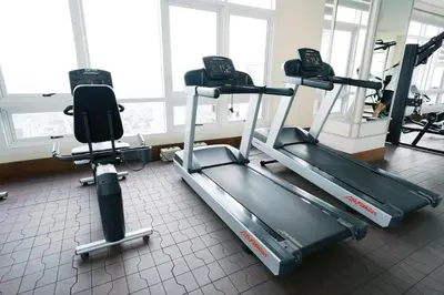 a gym with two treadmills and two machines at Mellow Dreams in Manila
