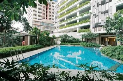 a swimming pool in a building with tall buildings at Mellow Dreams in Manila