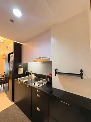 a kitchen with a sink and a stove in it at A&P Residence in Manila