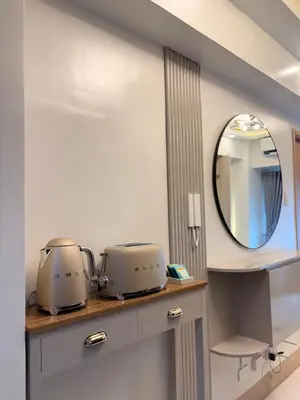 a bathroom with two toasters on a counter with a mirror at A&P Residence in Manila