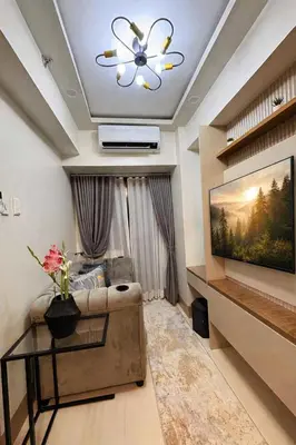 a living room with a couch and a ceiling fan at A&P Residence in Manila