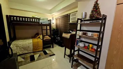 a room with two bunk beds and a christmas tree at McKinley viceroy Haven with free indoor parking in Manila