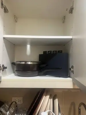 a frying pan sitting on a shelf in a kitchen at McKinley viceroy Haven with free indoor parking in Manila