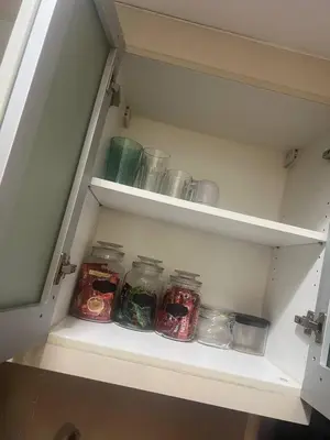 a drawer filled with glass jars in a cabinet at McKinley viceroy Haven with free indoor parking in Manila