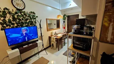 a living room with a flat screen tv on a stand at McKinley viceroy Haven with free indoor parking in Manila