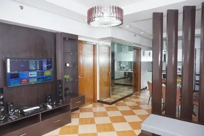 a living room with a television and a checkered floor at Eton Baypark Manila Bay in Manila
