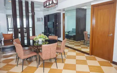 a dining room with a table and some chairs at Eton Baypark Manila Bay in Manila