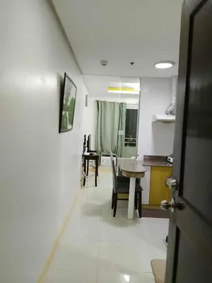 a kitchen and dining room with a table and chairs at Birch tower condo for renting in Manila