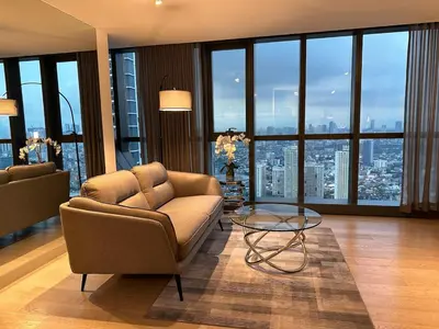 a living room with a couch and a glass table at New Modern Luxurious 1 Bedroom Condo with WIFI and Netflix in Manila