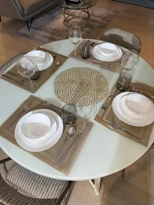 a white table with plates and wine glasses on it at New Modern Luxurious 1 Bedroom Condo with WIFI and Netflix in Manila
