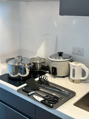 a kitchen counter with pots and pans on a stove at New Modern Luxurious 1 Bedroom Condo with WIFI and Netflix in Manila