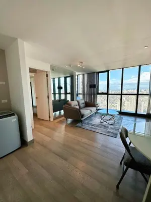 a living room with a couch and a table at New Modern Luxurious 1 Bedroom Condo with WIFI and Netflix in Manila