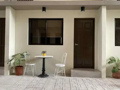 a table and chairs in front of a house at 88 Residences in Manila