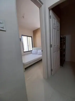an open door to a bedroom with a bed and a window at 88 Residences in Manila