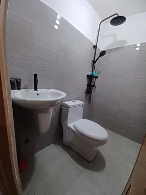 a bathroom with a toilet and a sink at 88 Residences in Manila