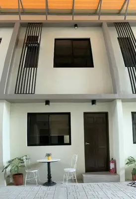 a house with two chairs and a table in front of it at 88 Residences in Manila
