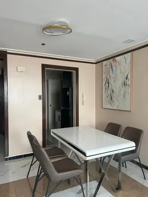 a dining room with a white table and chairs at Robinson's Place Residences, tower 2 in Manila