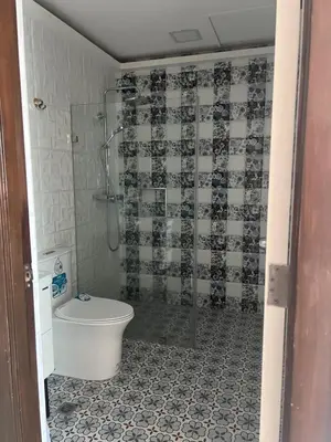 a bathroom with a shower and a toilet in it at Robinson's Place Residences, tower 2 in Manila