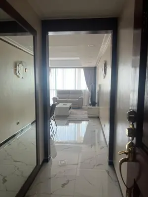 a hallway leading to a living room with a couch at Robinson's Place Residences, tower 2 in Manila