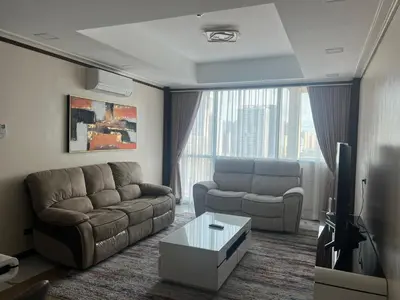 a living room with a couch and a tv at Robinson's Place Residences, tower 2 in Manila
