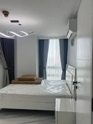 a bedroom with a bed and a window at Robinson's place residences tower 2 in Manila