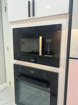 a microwave oven sitting inside of a cabinet at Robinson's place residences tower 2 in Manila