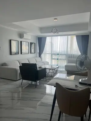 a living room with couches and chairs and a table at Robinson's place residences tower 2 in Manila
