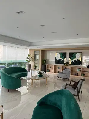 a living room with a green couch and chairs at Luxe Hotel-Style Suite Stay at Ayala Ave in Manila