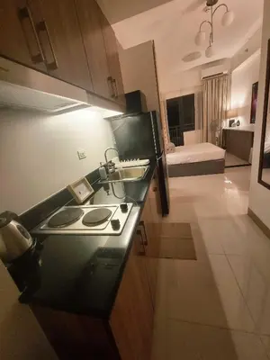 a kitchen with a sink and a kitchen with a bed at Luxe Hotel-Style Suite Stay at Ayala Ave in Manila