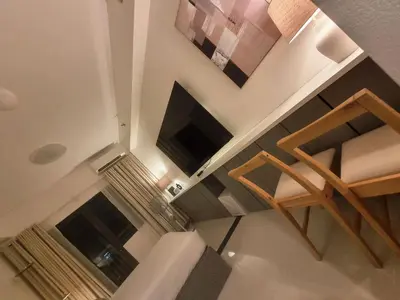 an overhead view of a living room with a flat screen tv at Luxe Hotel-Style Suite Stay at Ayala Ave in Manila