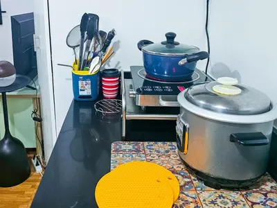 a kitchen with a stove and a pot on a counter at CitiClcentro Condo Near everything in Manila