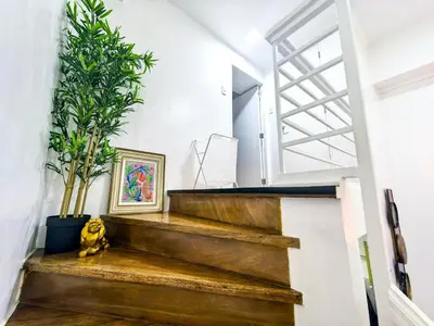a staircase in a house with wooden steps and plants at CitiClcentro Condo Near everything in Manila