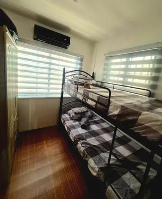 a bunk bed in a room with a window at Casa Deña Lawa - Cozy Staycation in Calamba in Calamba