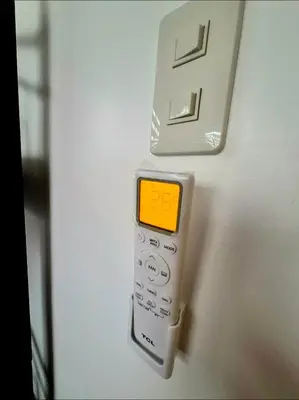 a white remote control hanging on a wall at Casa Deña Lawa - Cozy Staycation in Calamba in Calamba