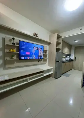 a living room with a flat screen tv on a wall at Affordable Staycation in Pasay near MOA in Manila