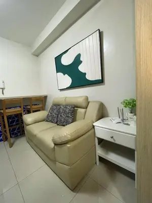 a living room with a couch and a table at Affordable Staycation in Pasay near MOA in Manila