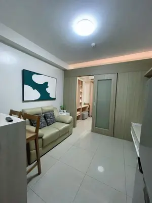 a living room with a couch and a table at Affordable Staycation in Pasay near MOA in Manila