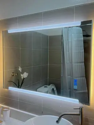 a mirror in a bathroom with a sink and a toilet at Affordable Staycation in Pasay near MOA in Manila